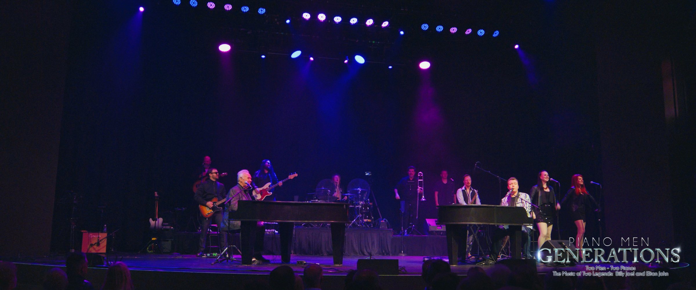 The full band under stage lights